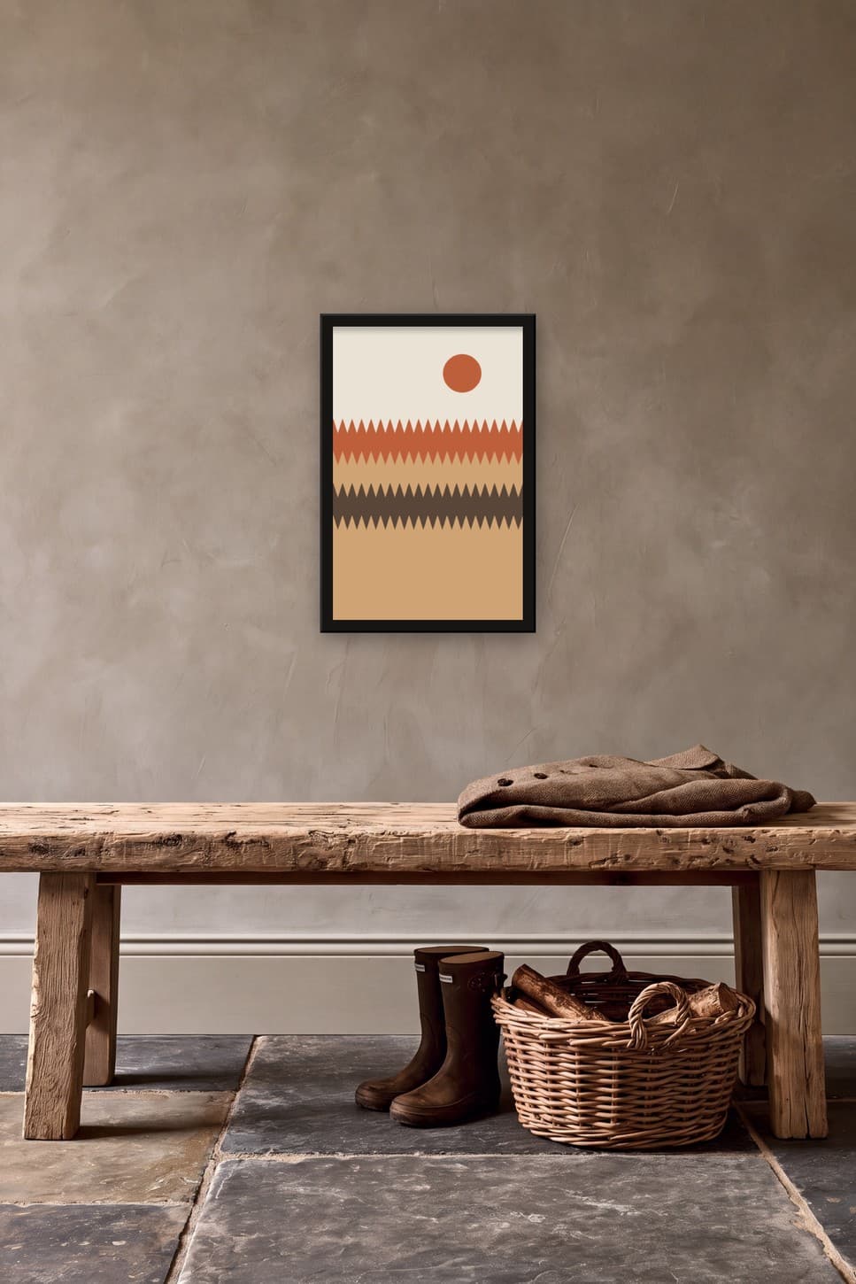 Terracotta wave poster in a thin black frame on a greige hallway wall above a rustic pine bench