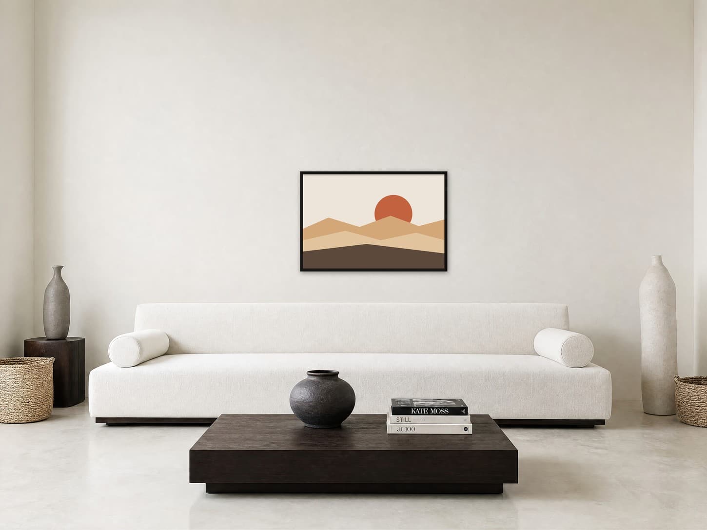 Terracotta mountain sunset landscape poster in a thin black frame above a long white sofa