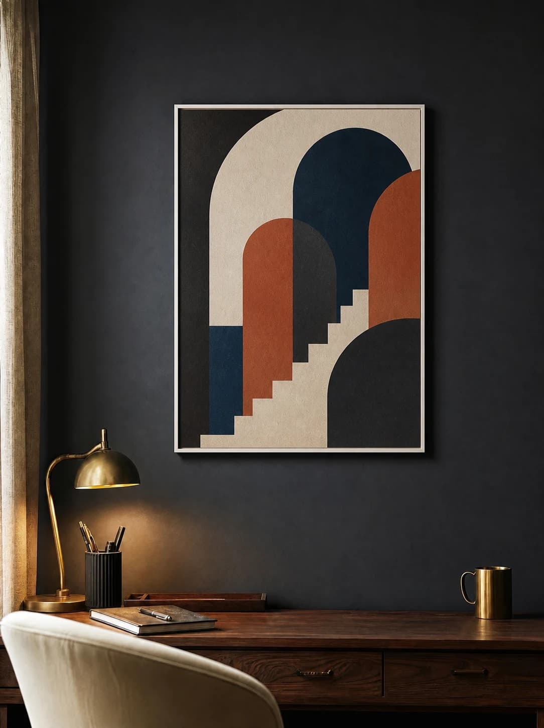 Geometric art mockup in a white frame above a desk on a charcoal wall