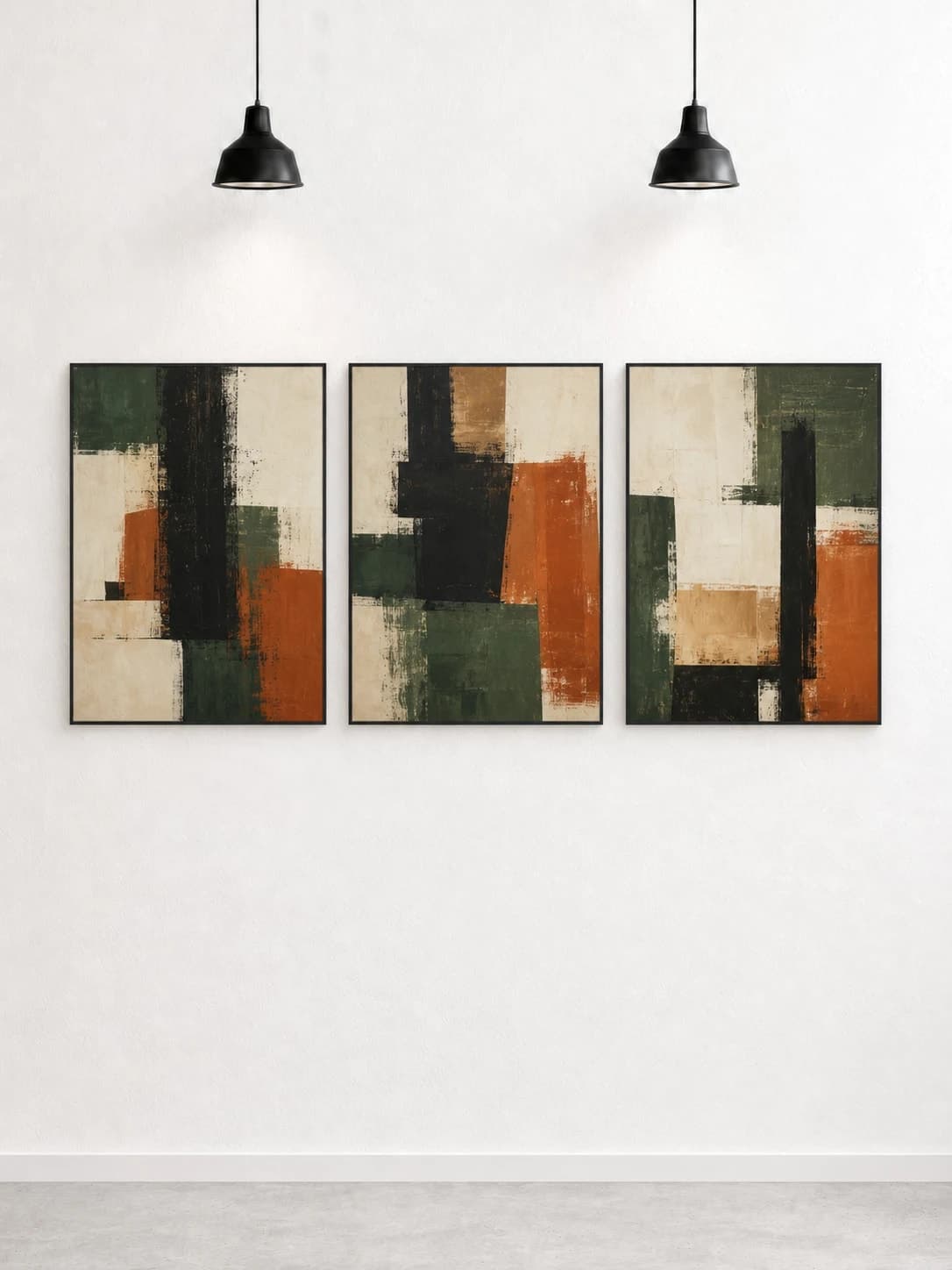 Three forest green and rust abstract works in black frames on a white gallery wall