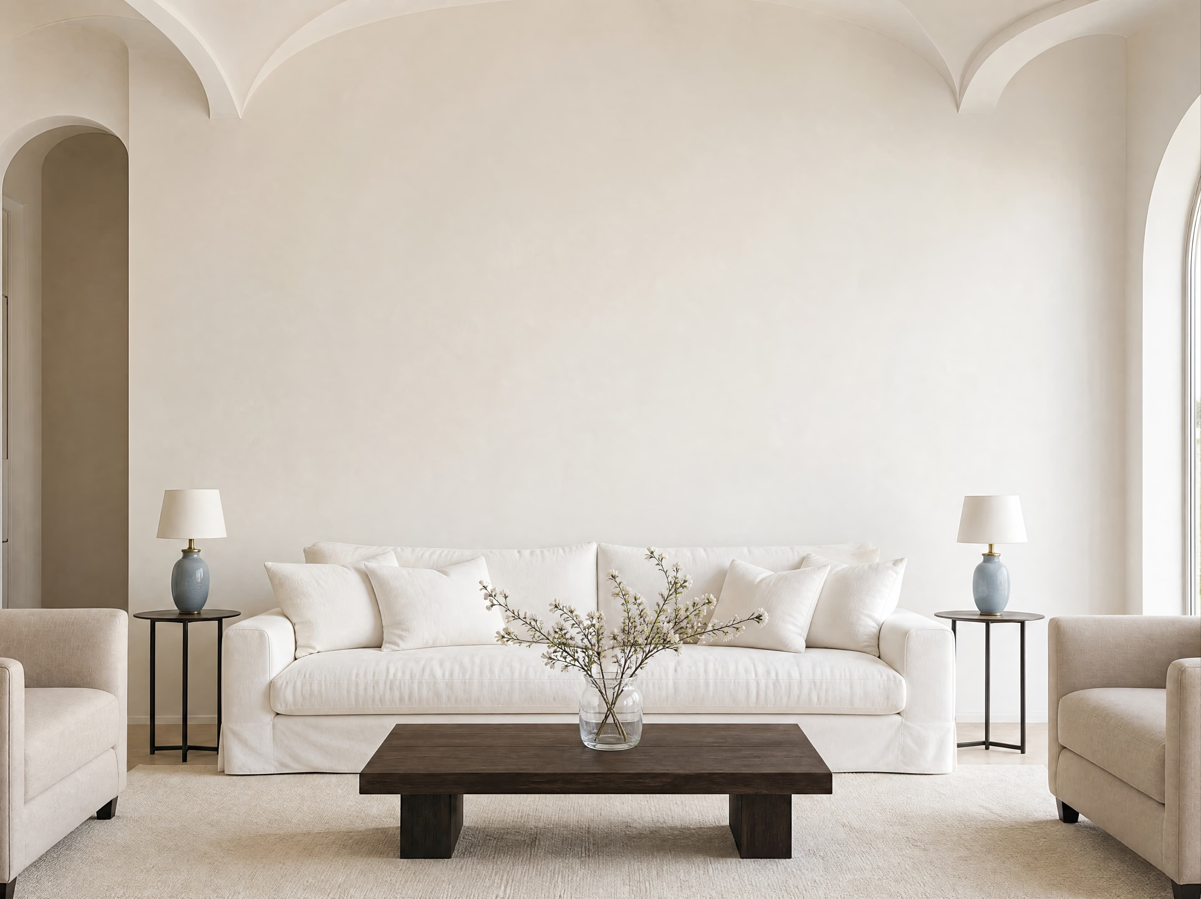 Airy symmetrical living room with a broad warm-white wall above a relaxed white sofa, ranked 11 among triptych mockups