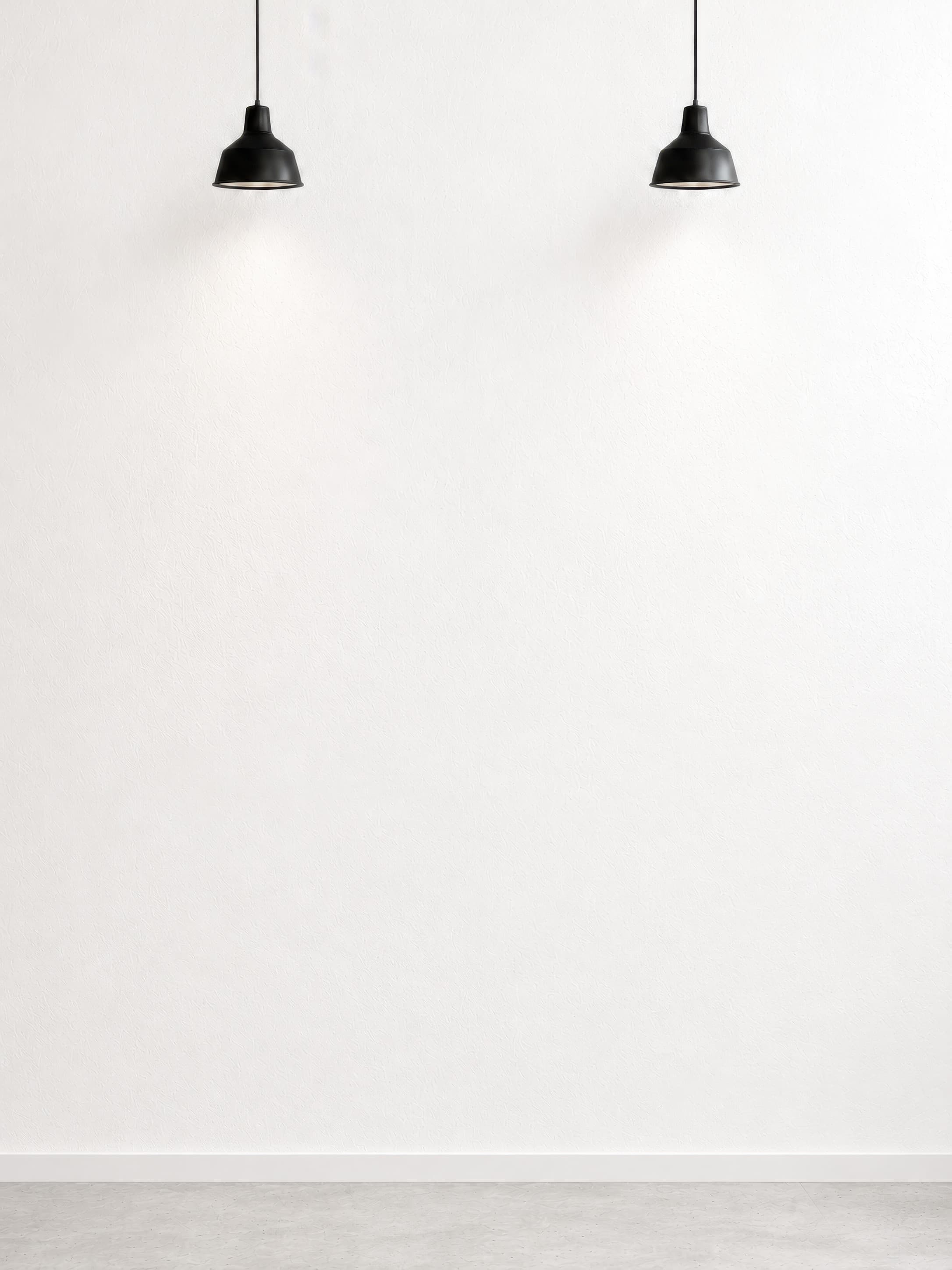 Minimal gallery wall mockup with a bright empty white textured plaster wall, black pendant lights, and a pale gray floor, ranked 3 among triptych mockups
