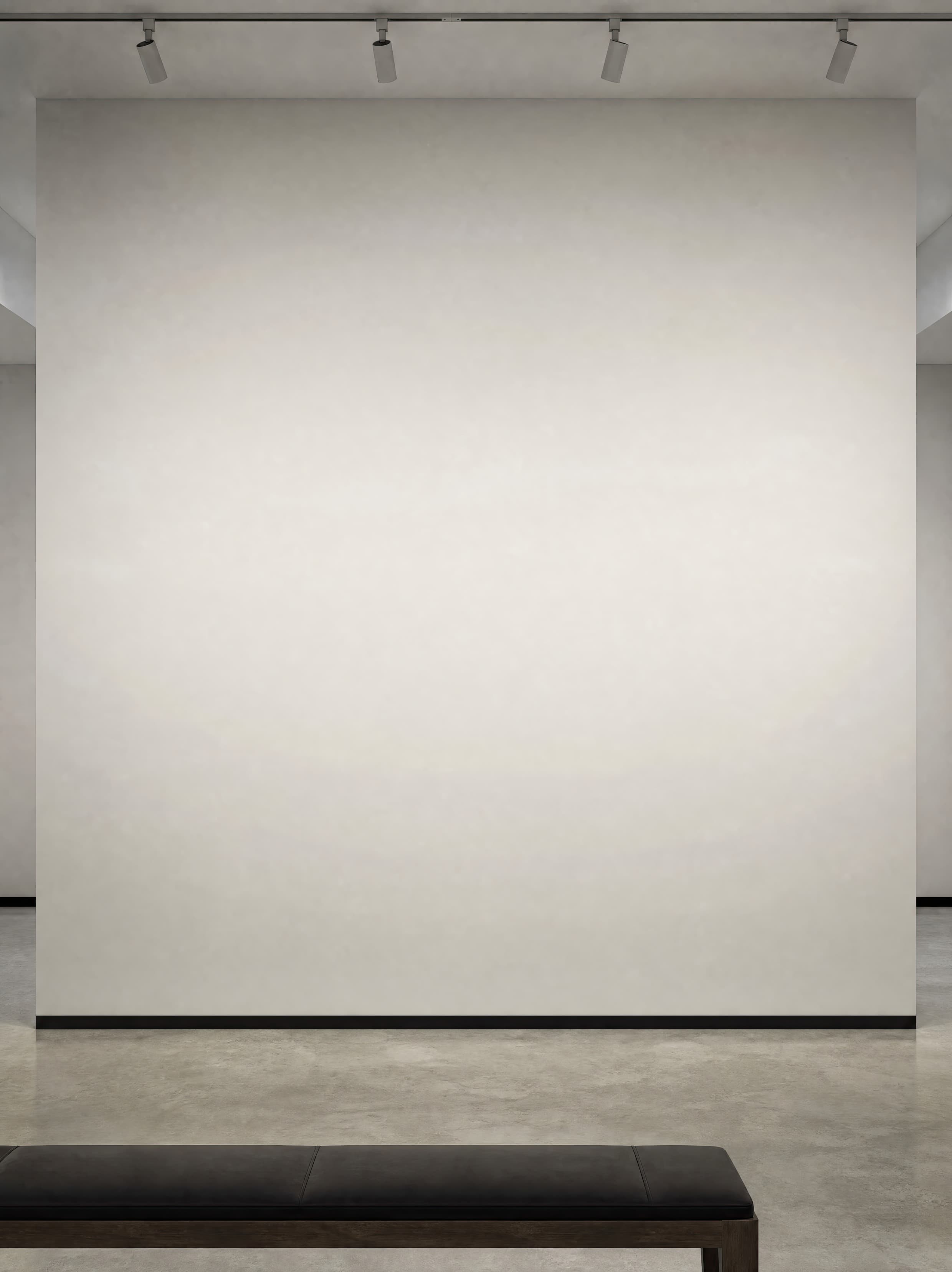 Contemporary gallery alcove with an empty light gray wall, track lighting, concrete floor, and a low bench, ranked 9 among exhibition mockups