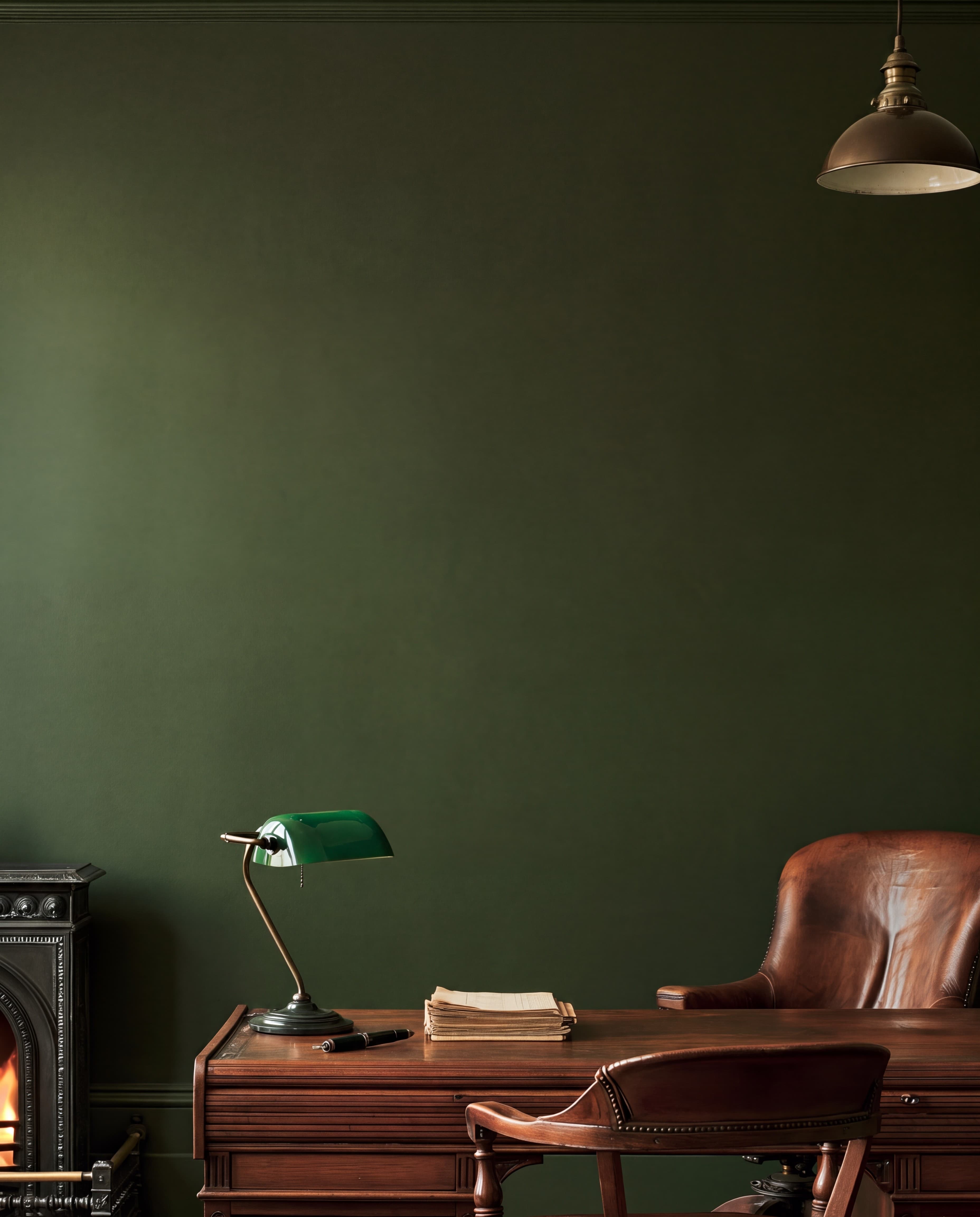 Victorian study with a deep olive wall, mahogany desk with a green banker's lamp, leather chair, and small cast-iron fireplace, ranked 14 among 11x17 poster mockups