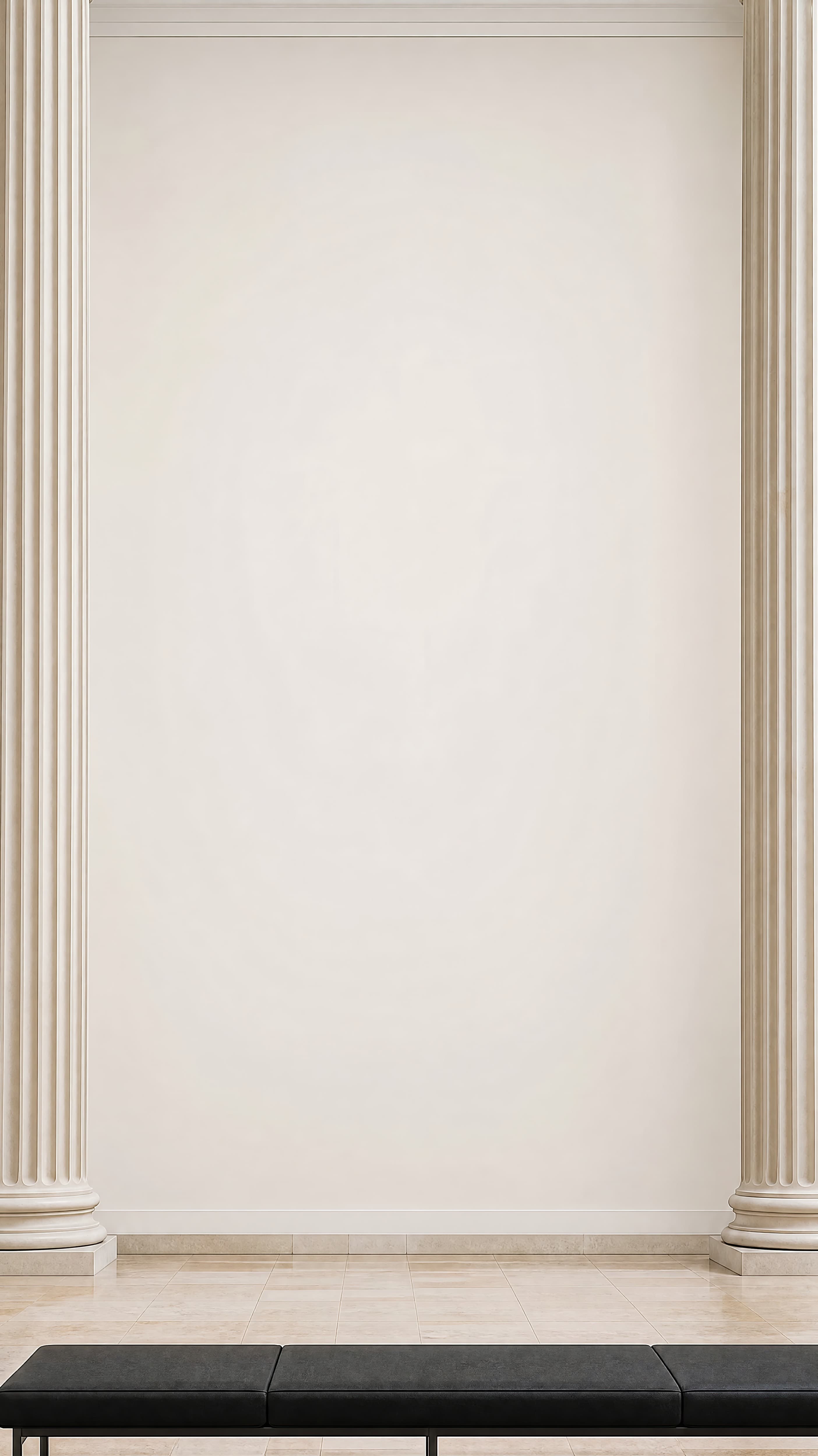 Grand neoclassical gallery with an empty ivory wall framed by fluted columns and a low black bench, ranked 18 among exhibition mockups