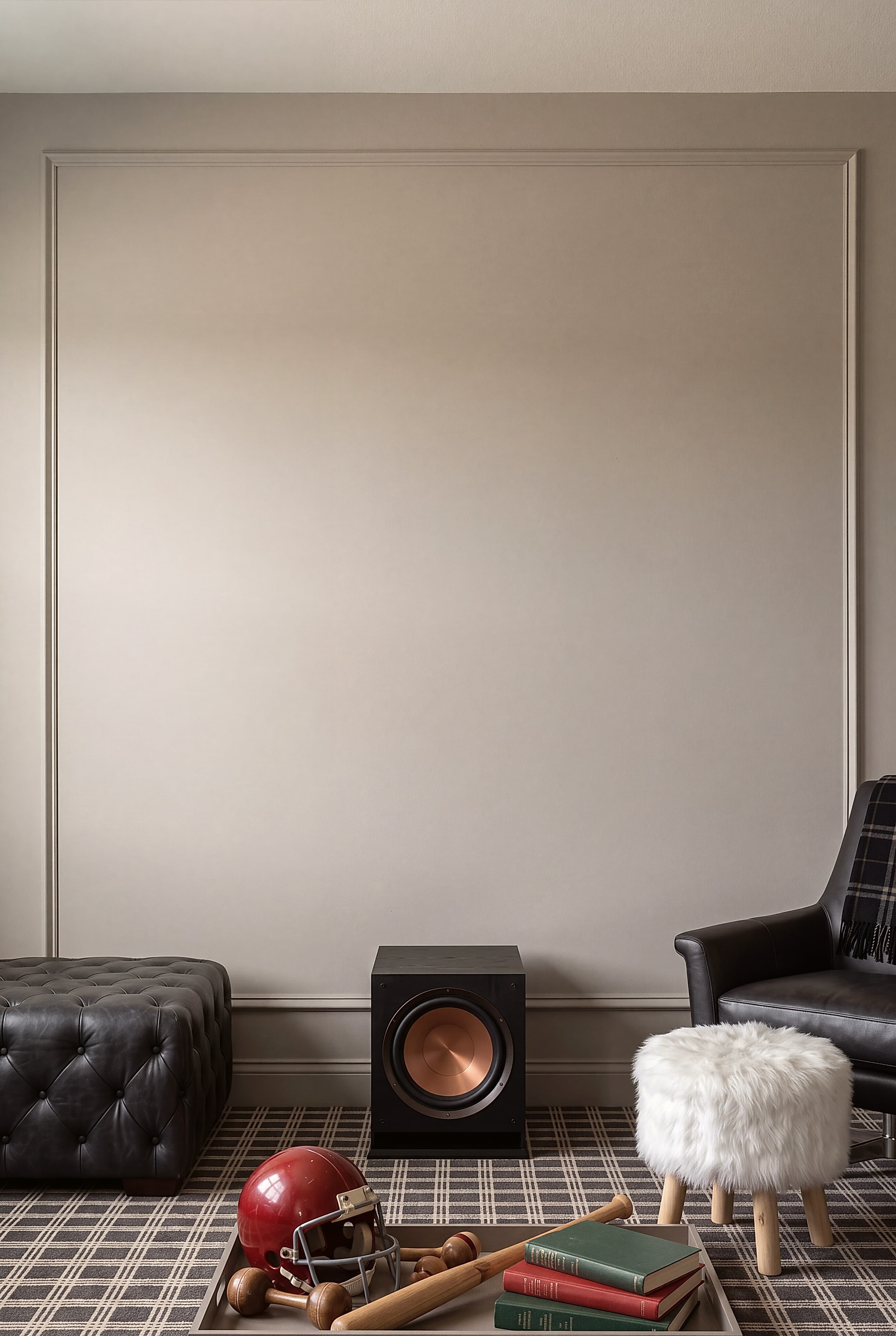 Man cave Living room with tufted leather ottoman and subwoofer speaker, ranked 1 among man cave mockups