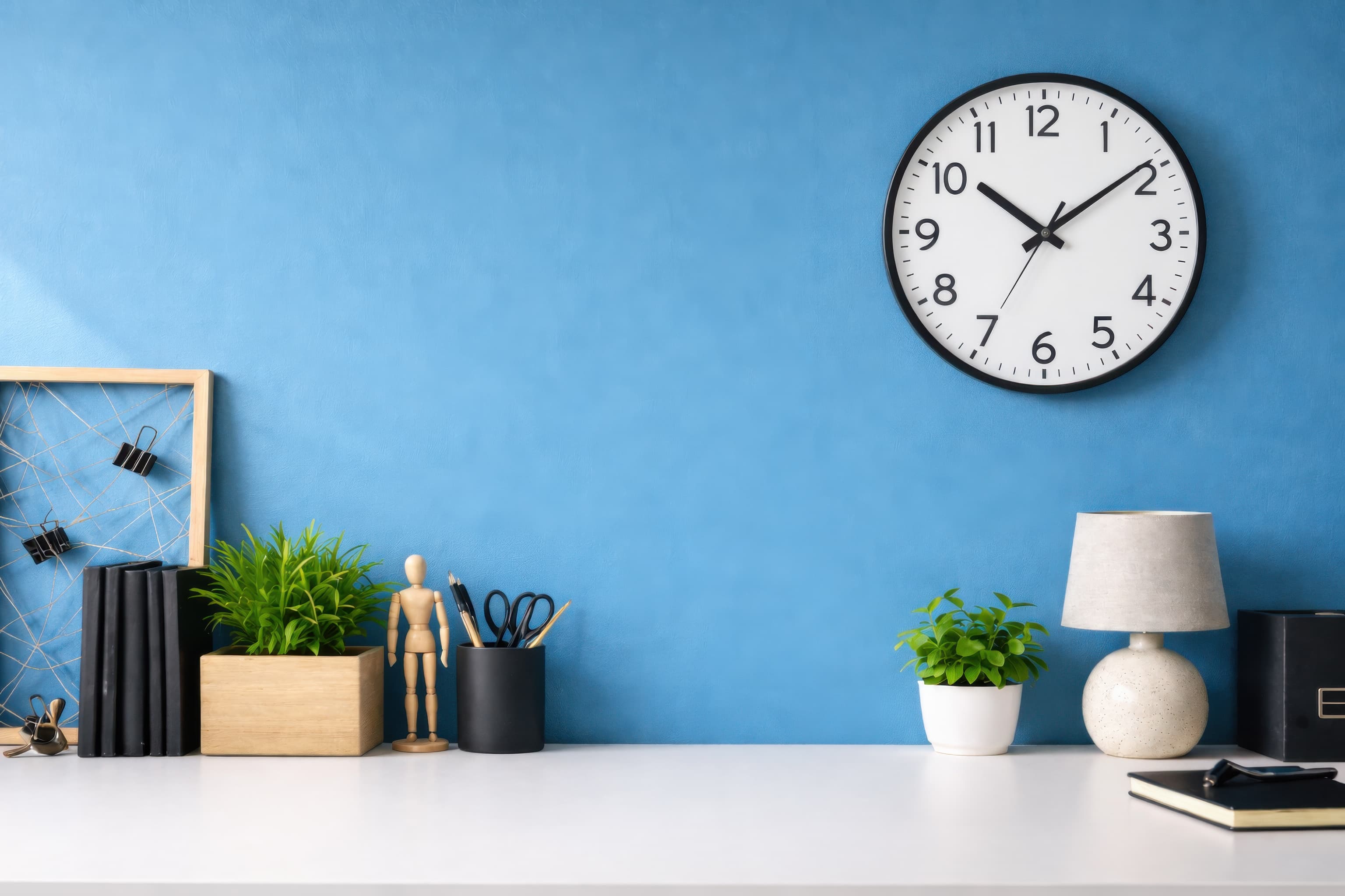 Minimalistic desk against blue wall, ranked 6 among blank-wall mockups