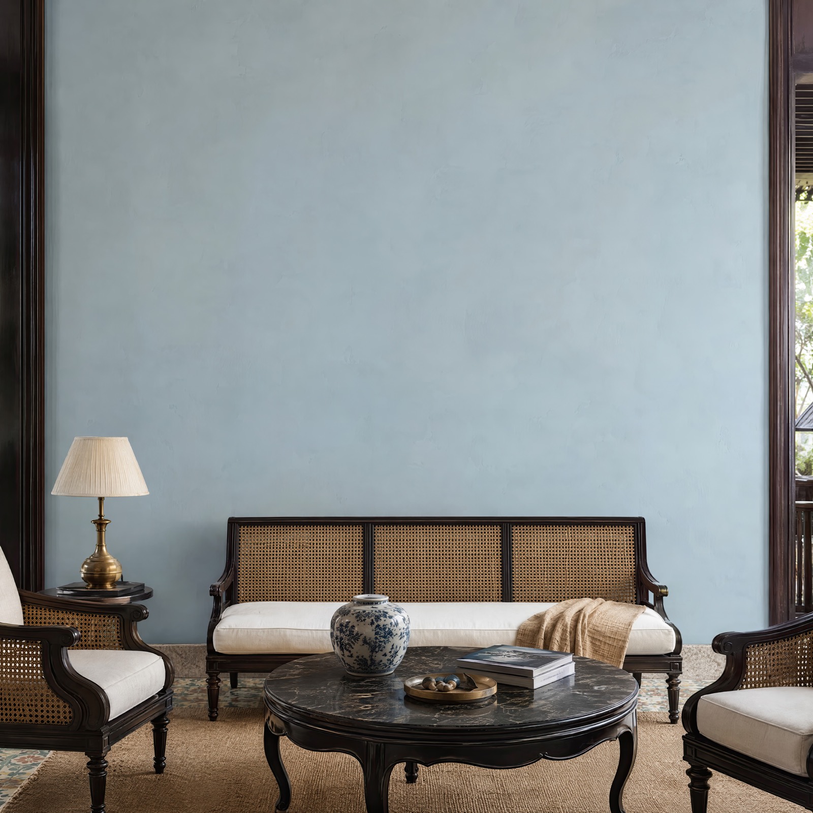 Square powder blue wall with lacquered timber and cane seating in the Vietnamese-inspired salon room