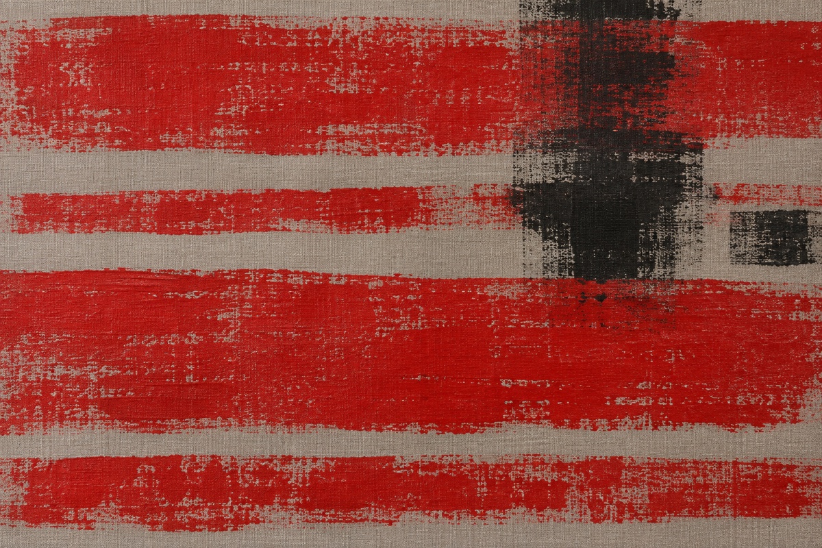 Tight overhead crop of red, black, and warm-gray abstract bands showing controlled broken brayer texture and one cross-direction interruption