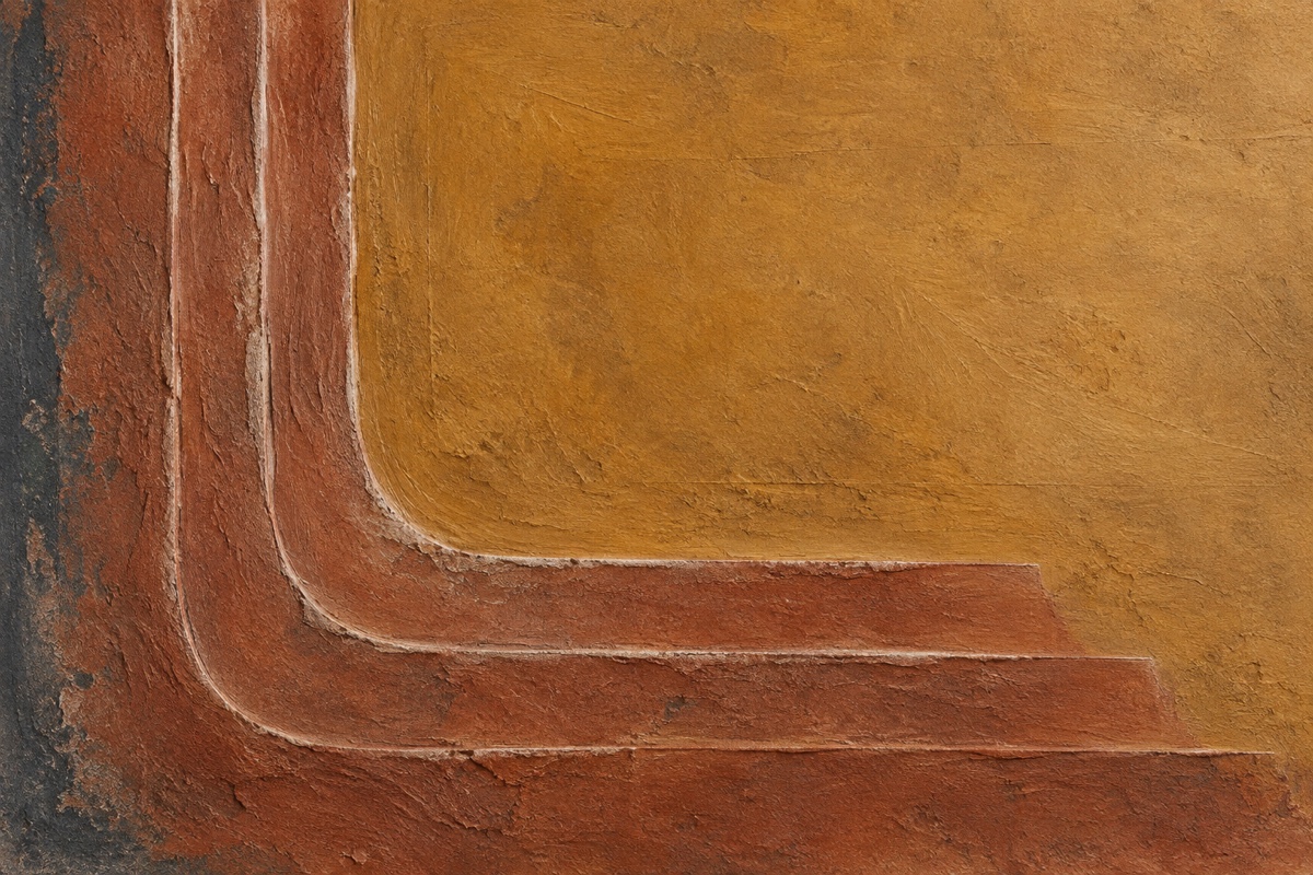 Tight overhead crop of sanded modeling-paste relief stained with raw sienna and transparent red iron oxide, with pale ridge tops visible