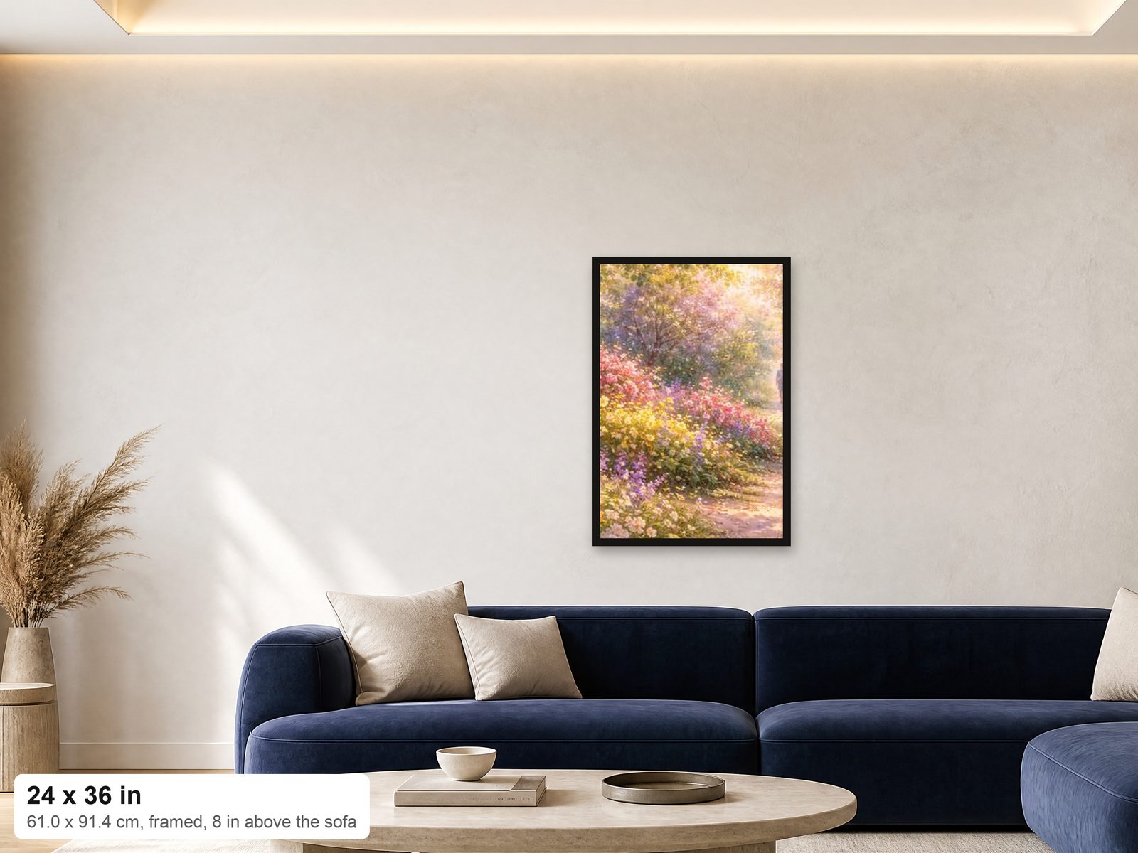 A 24x36 framed print shown at true scale on a wall above a navy sofa